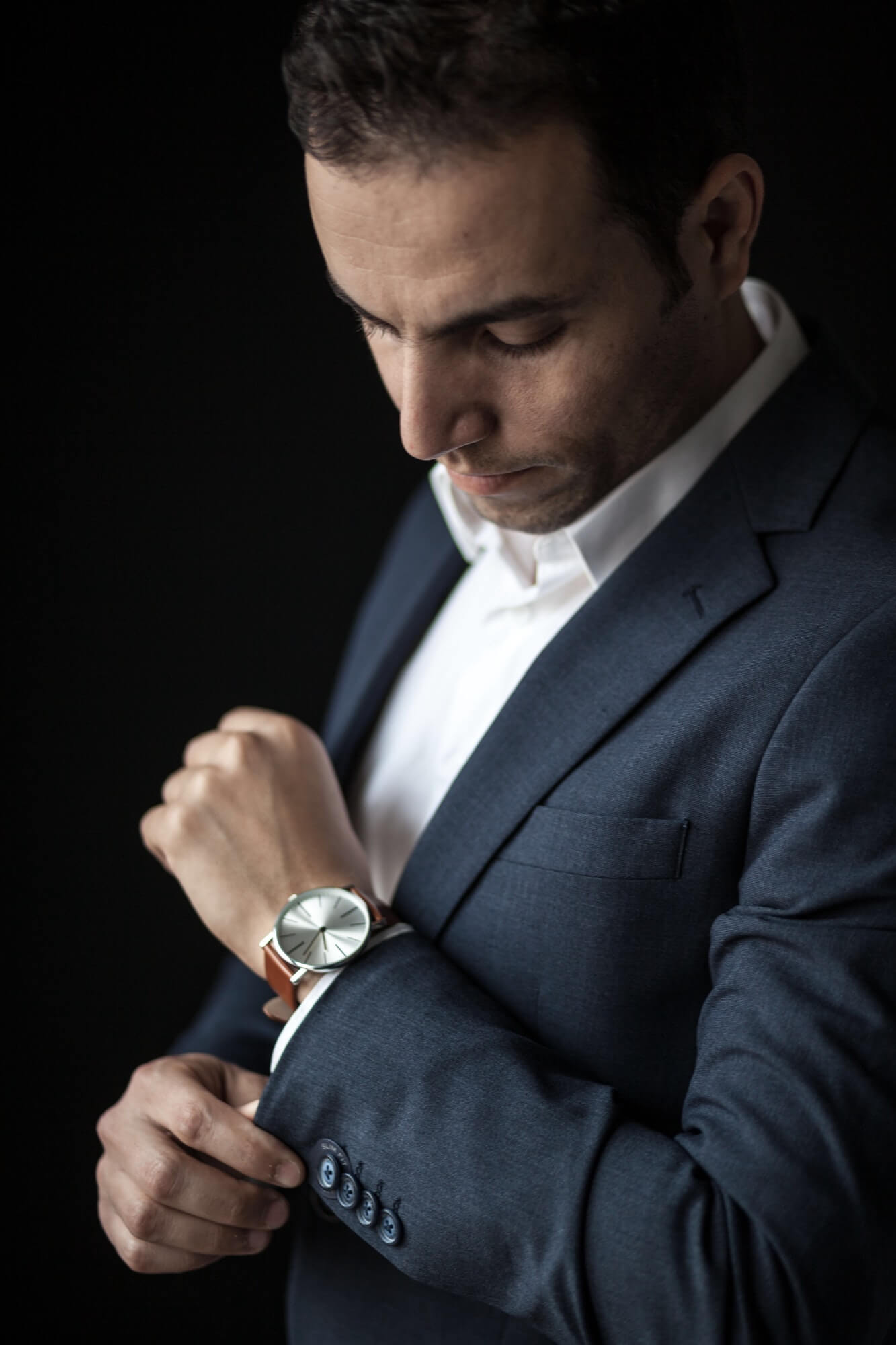 man-adjusting-his-sleeves-wearing-a-watch-1.jpg