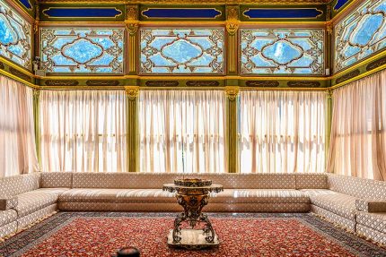 Elegant Ottoman-Style Interior with Traditional Décor and Intricate Stained Glass